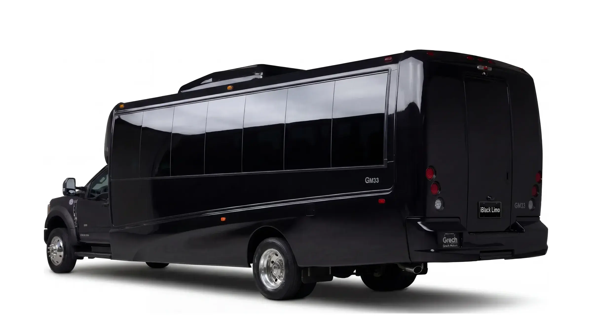 Black luxury mini coach, rear three-quarter studio view on white